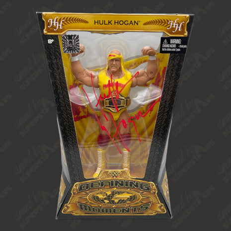 Hulk Hogan signed WWE Defining Moments Action Figure (w/ Hogans Beach Shop COA)